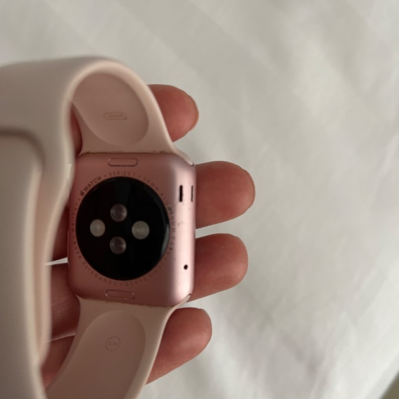 Rose gold series 1 Apple Watch with charger